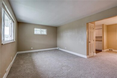 The living room leads into the dining room and kit