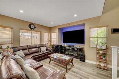 Living room featuring baseboards, light wood-style