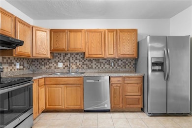 Open kitchen concept with tile back splash.