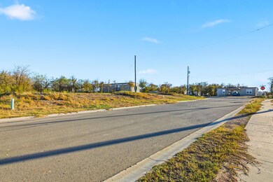 View of asphalt road featuring curbs