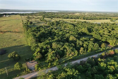 Aerial view of property's location with a nearby body of water and rural landscape