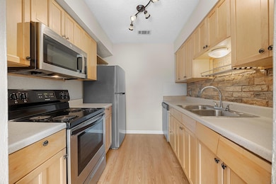 Kitchen featuring appliances with stainless steel