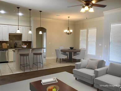 Tiled living room featuring sink, ceiling fan with