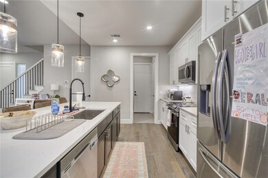 Kitchen featuring visible vents, wood finished flo
