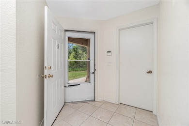 Doorway to outside with light tile patterned floor