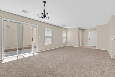 Carpeted spare room with a chandelier and baseboar