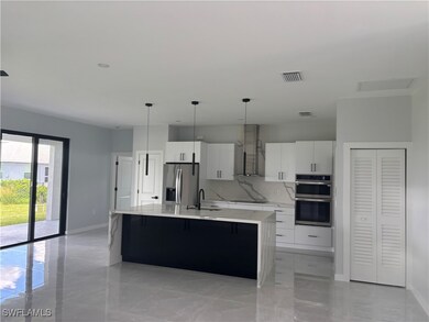 Kitchen with stainless steel appliances, wall chim