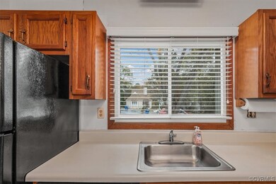 Kitchen with black fridge and sink