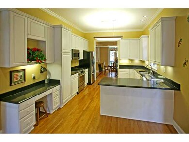 Updated kitchen has hardwood, stainless steel, and