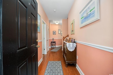 Doorway to outside featuring light wood finished floors and baseboards
