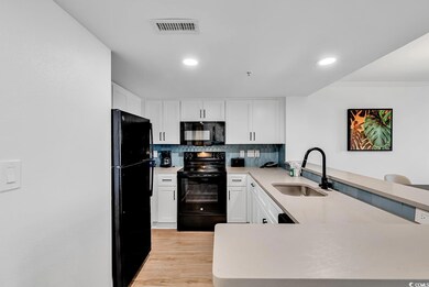 Kitchen featuring visible vents, decorative backsp