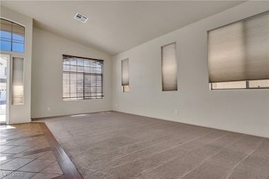 Spare room with vaulted ceiling, inlaid floor deta