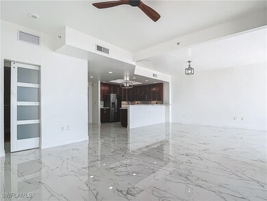 Unfurnished living room featuring a ceiling fan, l