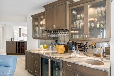 Wet bar offers a wine cooler, clear icemaker, water. Exotic granite countertop.
