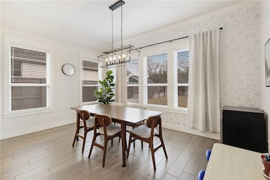 Dining space with wallpapered walls, an inviting c