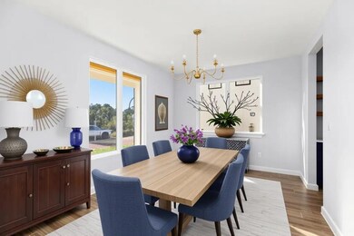 Dining area featuring a chandelier, light wood fi