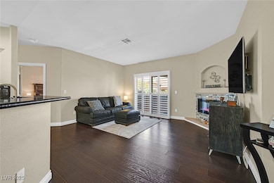 Living area featuring wood-style floors, a glass c