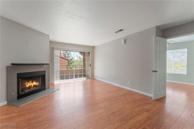 Living room with fireplace and balcony access