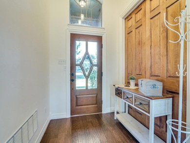Entrance foyer with dark hardwood / wood-style flo