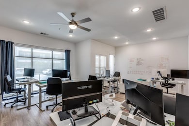 Office area featuring light wood-style floors, recessed lighting, and ceiling fan
