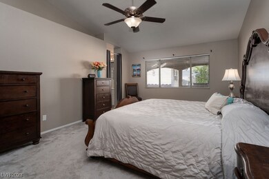 Large, bright primary bedroom with vaulted ceiling