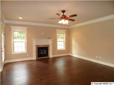 Family room with hardwood floors, fireplace, recessed lights, and ceiling fan.