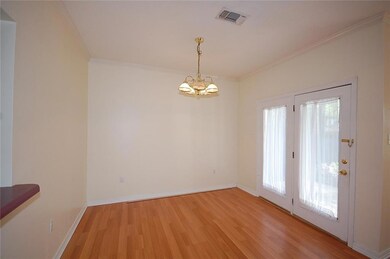 Dining Room. Door leads to concrete Patio.