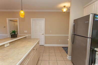 Kitchen with hanging light fixtures, crown molding