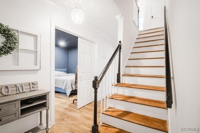 Staircase featuring wood-type flooring and ornamen