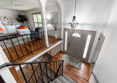 Foyer featuring wood finished floors and arched walkways