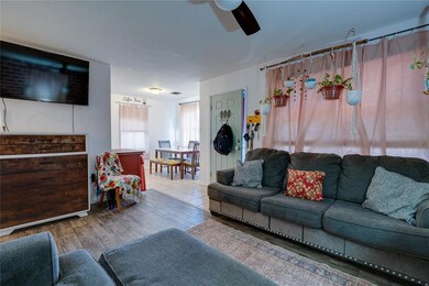 Living room with ceiling fan and hardwood / wood-s