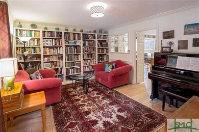 Library with door leading to the kitchen.