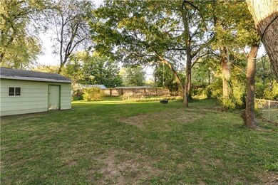 Large fenced in yard with small garden area.