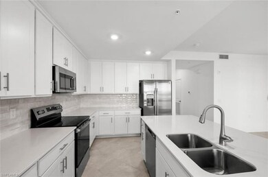 Kitchen with visible vents, a sink, stainless steel appliances, white cabinetry, and backsplash