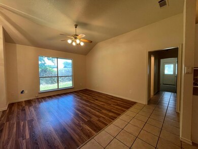 Empty room with tile floors, ceiling fan, and vaul