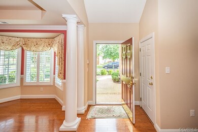 Front door into the foyer with crown molding and b