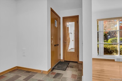 Foyer entrance featuring stone tile floors
