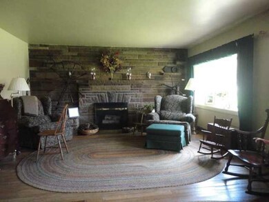 Living Room. A native stone fireplace is the cente