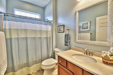 Upgraded with Quartz vanity top and framed mirror, transom window adds extra natural light
