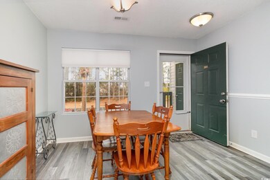 Dining area with light wood-style floors, visible 