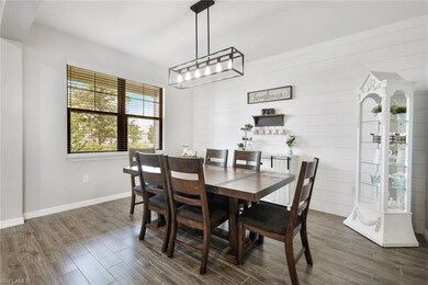 Dining room with wood walls, dark hardwood / wood-