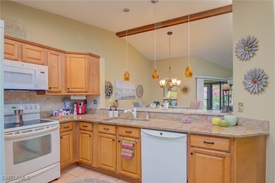 Kitchen featuring white appliances, a sink, light
