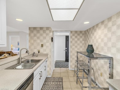 Kitchen featuring dishwasher, sink, light tile pat