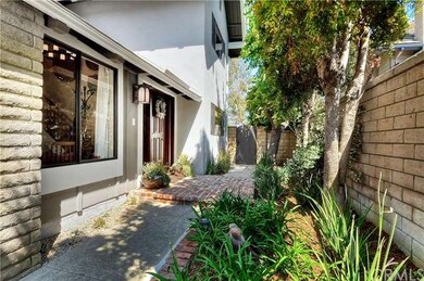 Brick entry with new custom wood door and plenty o