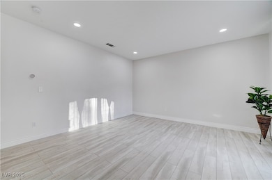 Unfurnished room featuring light wood-style floors and recessed lighting