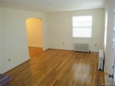 View of Living Room and arched doorway leading to Dining Room.