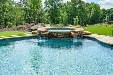 View of swimming pool featuring pool water feature