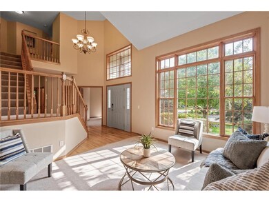Family room with large windows letting in lots of 