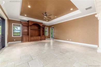 Family Room with tray ceiling and french design tr