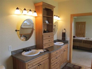 Double vanity in the master bath is anchored by bu